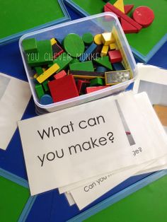 a plastic container filled with lots of colorful magnets next to a sign that says what can you make?