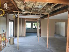 an unfinished room with wood framing and electrical wires hanging from the rafters on the ceiling