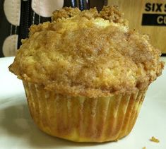 a close up of a muffin on a plate with a box in the background