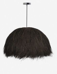 an animal's hair is hanging from a metal hook on a white background,