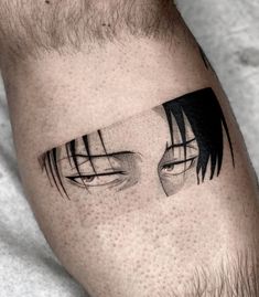 a man's arm with an eye tattoo on it