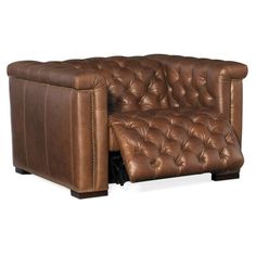 a brown leather couch sitting on top of a white floor