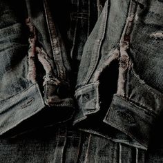 two pairs of blue jeans with holes in them