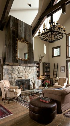 a living room filled with furniture and a fire place in the middle of a room