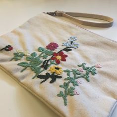 an embroidered purse sitting on top of a table