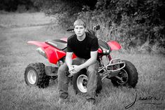 a man sitting on an atv in the grass