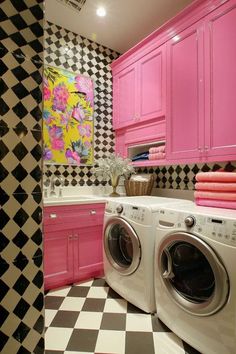 a washer and dryer in a room with black and white checkered walls