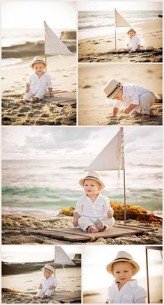 a little boy sitting on top of a sandy beach next to the ocean wearing a hat