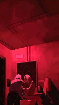 two people sitting at a table in a room with red light coming from the ceiling