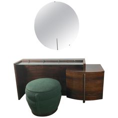 a vanity with mirror, stool and round mirror on it's sideboard in the style of paul mcc