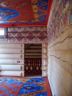 the inside of a house with colorful carpet and walls