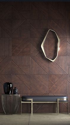 a bench and table in front of a wall made of wood planks with geometric shapes