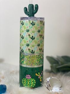 a green cactus canister sitting on top of a white furnishing covered floor