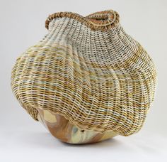 a wicker basket sitting on top of a white table