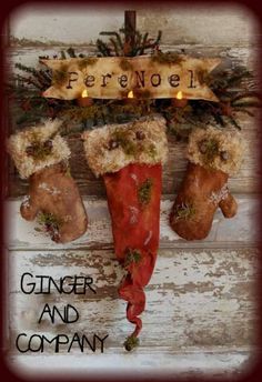 ginger and company christmas stockings hanging on the wall with candles in it's holders