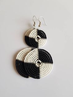 "**Naecklace comes with matching earrings. This necklace is 100% handcrafted using white and black beads. Measurements: 18 inches around the neck. Pendant: 4\" Earrings; 4\" long. Perfect for weddings, African themed events, traditional events etc. **Buy multiple items and pay shipping for 1 item only.The rest ships free. More neckleces here; https://www.etsy.com/shop/TribalTess?ref=seller-platform-mcnav&section_id=21306083 Back to my shop; https://www.etsy.com/shop/TribalTess?ref=seller-pla Gift White Beaded Earrings With Black Beads, White Beaded Earrings With Black Beads, Beaded Black And White Jewelry Gift, White And Black Beaded Earrings, African Jewelry Earrings, White Beaded Necklaces, Jewelry Organizer Wall, Wholesale Earrings, Beadwork Designs