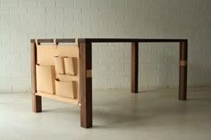 a table made out of wood with several pieces of paper attached to the back of it