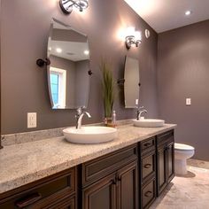 a large bathroom with two sinks and mirrors