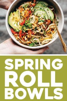 a bowl filled with noodles and vegetables on top of a green sign that says spring roll bowls