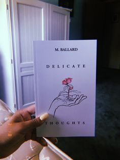 a person holding up a book in their hand with the title delicate thoughs written on it