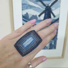 a woman's hand with a ring made out of crochet