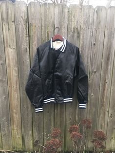 This is a great jacket for anyone that wants something different. If you want to look great anywhere you go, this is for you. If you are a public account in Ohio, it would be even better. It has some staining, pictured, but is still amazing. There are no rips, holes or smells. Measurements: Pit to pit: 24 1/4 inches Collar to bottom front: 23 inches Collar to bottom back: 25 inches 32 inches Sleeve Length (from collar): Size on tag: Large Black Varsity Jacket With Buttons, Fall Black Varsity Jacket With Snap Buttons, Classic Black Cotton Varsity Jacket, Black Buttoned Outerwear For College, Classic Black Windbreaker For Streetwear, Retro Streetwear Outerwear With Button Closure, Retro Outerwear With Button Closure For Streetwear, Black Long Sleeve Retro Windbreaker, Black Retro Windbreaker