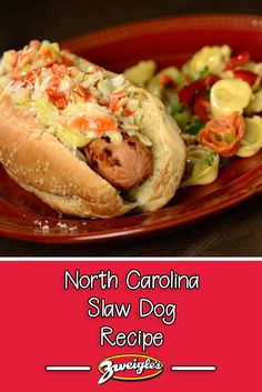 a red plate topped with a hot dog covered in coleslaw and garnish