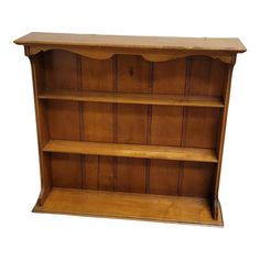 a wooden bookcase with three shelves on one side and two drawers on the other