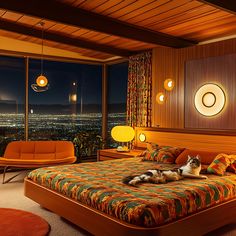 a cat laying on top of a bed in a bedroom next to a large window