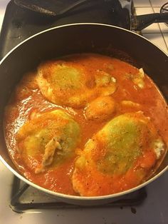 a pan filled with food sitting on top of a stove