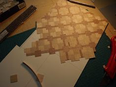 the wood is cut into squares and laying on the floor next to some construction tools