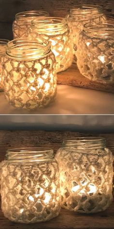 mason jars filled with candles sitting on top of a wooden table next to each other