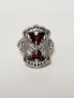 "Thanks for shopping our vintage estate store. We tend to sell well below wholesale and truly hope you enjoy all of our items. Many of the items are one of a kind, so please enjoy scrolling through the pictures and hopefully something will catch your eye. Estate sterling silver 925 natural 1ct garnet trillion cut filigree ring. Beautiful ring, one that was custom made in our shop, meaning we set the gems into the setting. Love this victorian style ring. Ring size: please select Setting: 5/8\" by 3/4\" 9mm Band width: 1.5mm Weight: 6.22 grams Beautiful ring one that you will love. Gems testing natural, but maybe created." Estate Style Collectible Gemstone Jewelry, Vintage Ruby Ring With Filigree For Wedding, Classic Jewelry For Valentine's Day, Classic Hallmarked Filigree Ring Collectible, Classic Hallmarked Filigree Ring For Collectors, Classic Silver Ruby Ring For Valentine's Day, Estate Oval Jewelry For Gifts, Estate Oval Jewelry For Anniversary, Estate Style Oval Jewelry For Anniversary