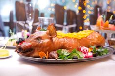 a plate that has food on it and is shaped to look like a boar's head