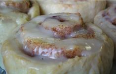 cinnamon rolls with icing sitting on a plate