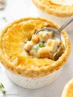 a close up of a spoon in a bowl filled with chicken pot pie casserole