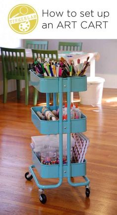 a blue cart filled with art supplies on top of a hard wood floor