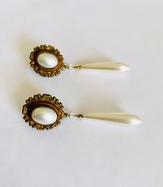 Lovely vintage costume jewelry post earrings with dramatic faux pearl drops and oval, bezel set faux oval cabochons with a clear crystal in gold toned setting. Great sparkle and movement in these elegant and dramatic Art Nouveau style earrings. Both earrings have some wear on the pearls as is expected with vintage - one oval has two tiny marks ... please see photos. Beautiful vintage drop earrings with free First Class domestic shipping! US sellers are not authorized to collect VAT/customs fees Vintage Drop Earrings For Pierced Ears, Victorian Teardrop Pearl Drop Earrings, Vintage Formal Drop Earrings, Formal Vintage Drop Earrings, Vintage Teardrop Earrings For Formal Occasion, Vintage Teardrop Metal Earrings, Vintage Teardrop Pearl Drop Earrings, Vintage Dangle Pearl Earrings, Vintage Teardrop Pearl Earrings For Pierced Ears