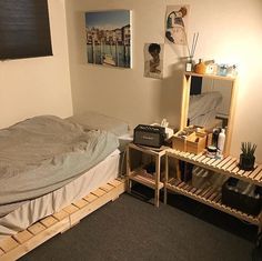 a bed room with a neatly made bed next to a wooden dresser and small mirror