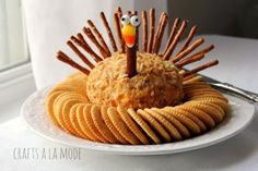 a plate topped with crackers and a turkey made out of crackers on top of it