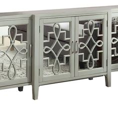 the sideboard is made out of wood and has mirrored doors on both sides with decorative designs