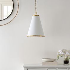 a white and gold lamp hanging from a ceiling in a room with a mirror on the wall