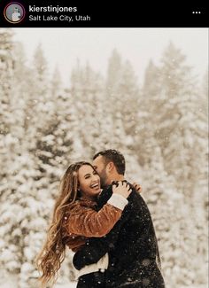 a man and woman are hugging in the snow