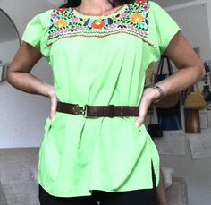 Beautiful vintage embroidered green, floral, Mexican blouse. The Mexican top is a beautiful green with brightly embroidered flowers on the front and back of the shirt.The blouse is lightweight and comfortable, perfect for the summer. It is made of 80% cotton and 20% polyester. The top is made in Mexico El Rebezo and is a size small.Please note a faint stain in the images and leather belt in not included.All items sold As Is. Any questions or concerns please contact me. Green Floral Embroidered Crew Neck Blouse, Green Cotton Top With Floral Embroidery, Green Embroidered Crew Neck Blouse, Green Crew Neck Blouse With Floral Embroidery, Casual Green Blouse With Floral Embroidery, Summer Green Blouse With Crew Neck, Green Crew Neck Blouse For Summer, Green Crew Neck Blouse For Spring, Green Bohemian Embroidered Top For Spring