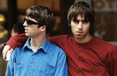 two young men standing next to each other in front of a store window with sunglasses on