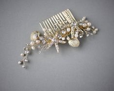 This beach-inspired comb is a delightful design of crystal starfish and textured shells. Ivory freshwater pearls and sprays of round crystal jewels surround these pretty stars. The decoration is about 5 inches by 2 inches. Visit my shop for more beach inspired designs to wear on your wedding day. https://www.etsy.com/shop/CassandraLynne Beachy Wedding Hair, Bride Hairstyles With Veil, Pretty Stars, Gold Bridal Hair Accessories, Beach Hair Accessories, Shell Mermaid, Starfish Wedding, Crystals Wedding, Pearl Beach