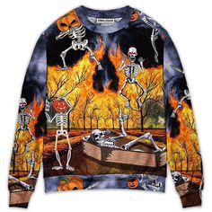 a long sleeved shirt with skeletons and pumpkins on it, in front of a fire