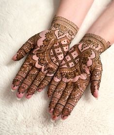 two hands with henna designs on them