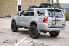 a silver four door suv parked in a parking lot