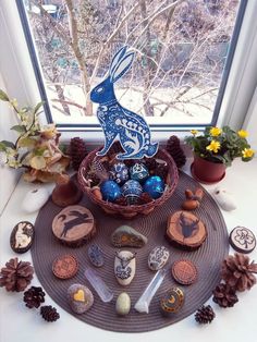 a basket filled with lots of different types of decorations on top of a window sill